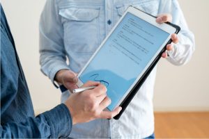 A professional applying a pp signature in a digital form.