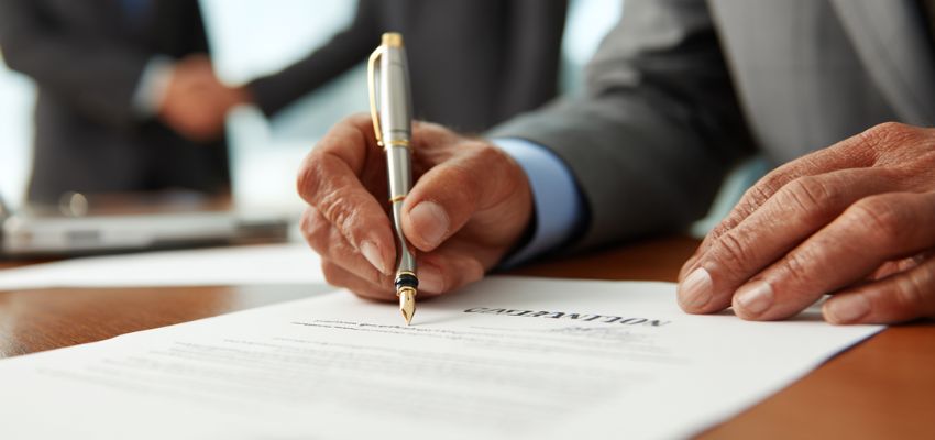 negotiate business contracts (1) The businessman signs a contract.