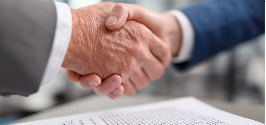 negotiate business contracts (2) The two businessmen are shaking hands as a sign of a contract deal.