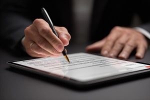 Close-up view of a businessperson finalizing a contract online using an advanced contract tool