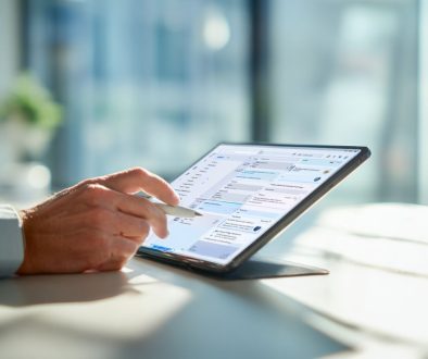 Man using a tablet to manage workflow tasks, showing how contract automation software streamlines document processes.