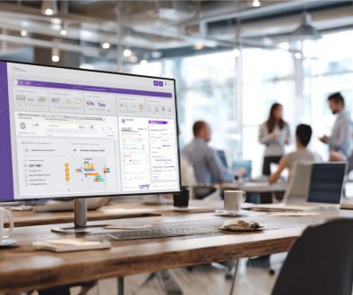 Widescreen monitor in a contemporary workspace displaying a comprehensive dashboard with task lists, timelines, and contract sections, representing intuitive contract collaboration software used by a busy team.