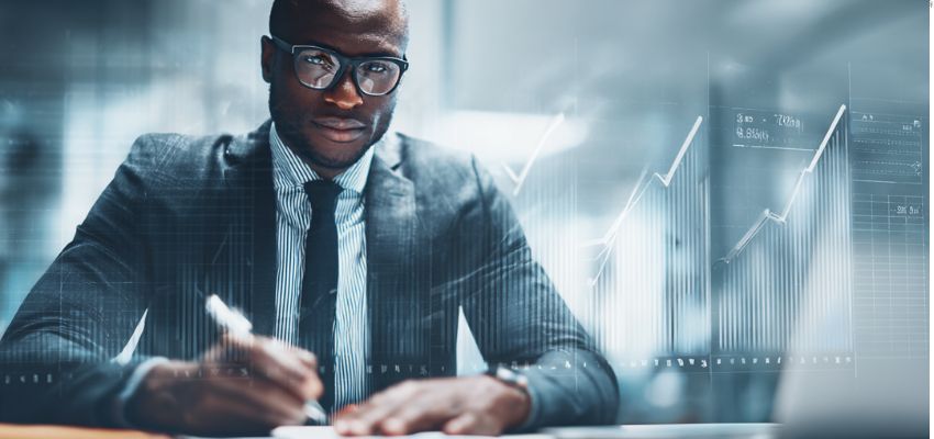 Analyst reviewing reports with digital dashboards during post contract management and compliance monitoring.