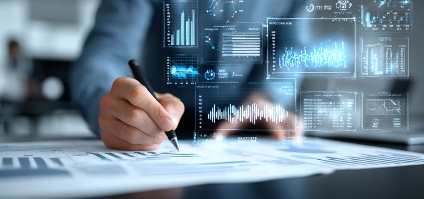 Business professional reviewing documents and financial charts during post contract management and performance tracking.