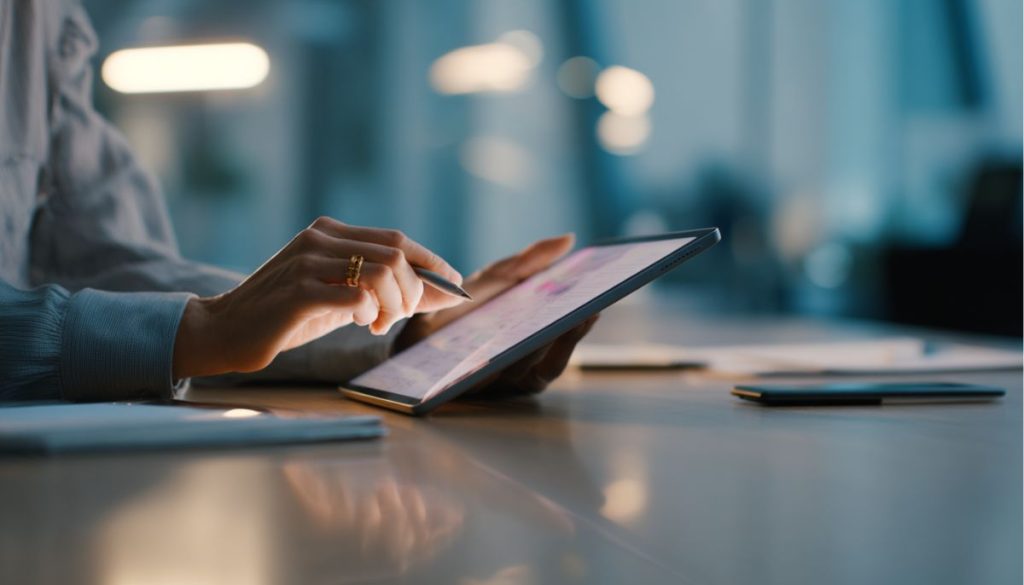 contract-strategies3 Close-up of hands using stylus to review contract strategies on a tablet device