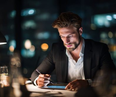 The businessman reviews the contract before signing it.