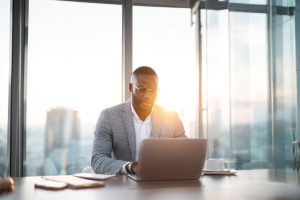 Business professional working on business law contracts in modern office